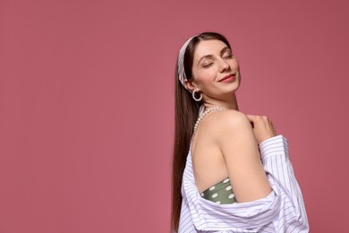 Photo of Fashionable portrait of beautiful woman in stylish outfit on pink background. Space for text