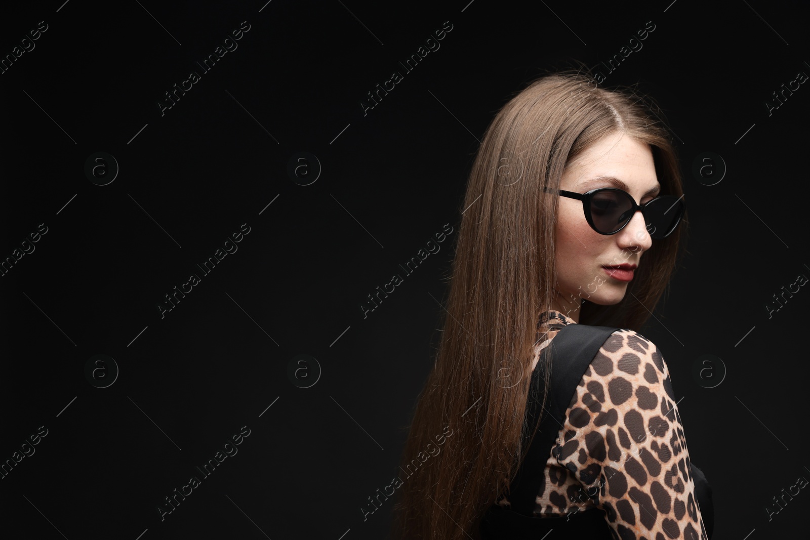 Fashionable portrait of beautiful woman in stylish outfit on black background. Space for text Photo of Fashionable portrait of beautiful woman in stylish outfit on black background. Space for text