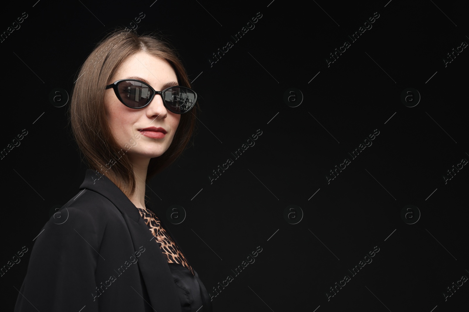 Fashionable portrait of beautiful woman in stylish outfit on black background. Space for text Photo of Fashionable portrait of beautiful woman in stylish outfit on black background. Space for text