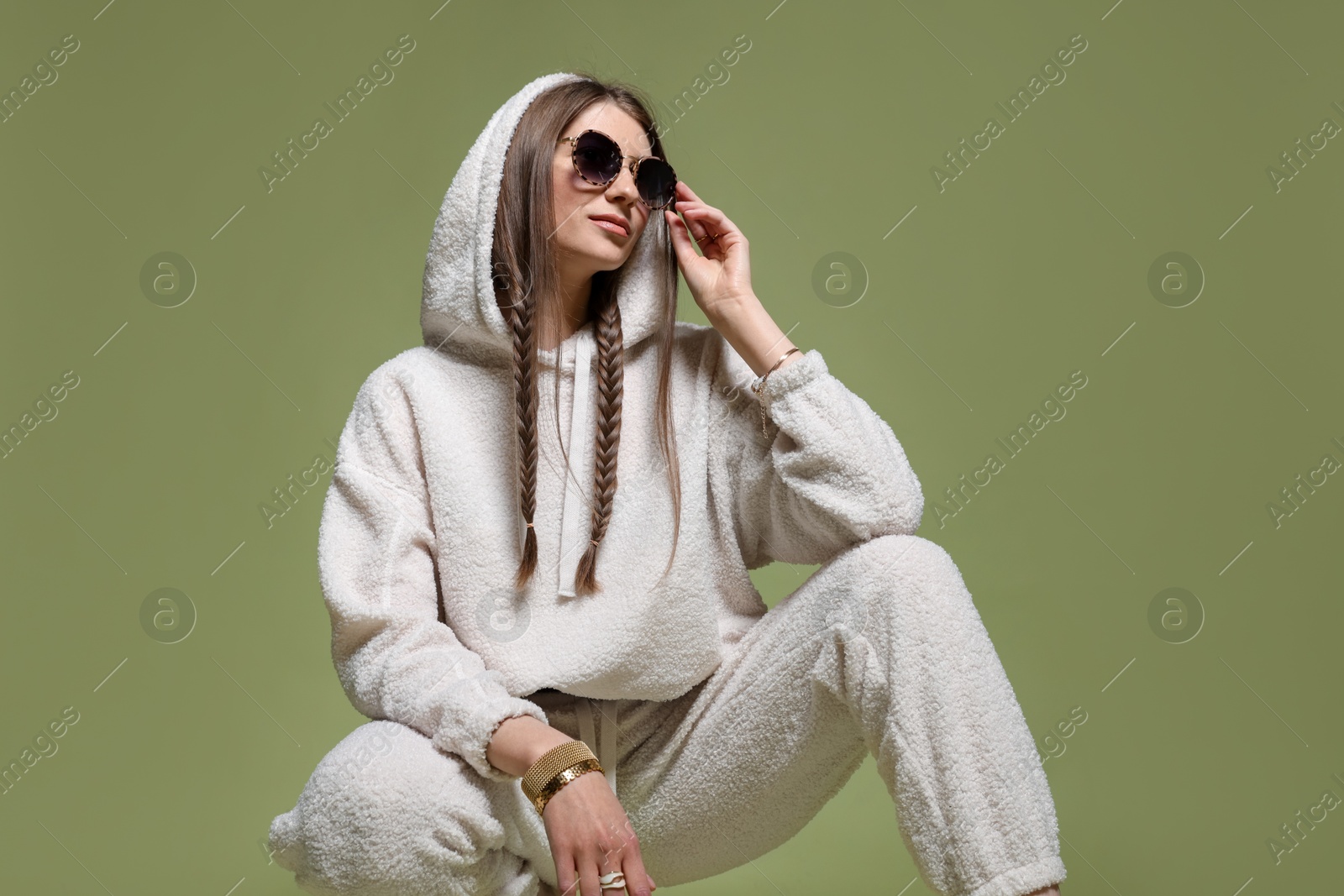 Fashionable portrait of beautiful woman in stylish outfit on green background Photo of Fashionable portrait of beautiful woman in stylish outfit on green background