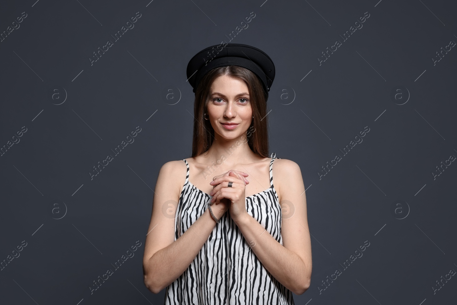 Fashionable portrait of beautiful woman in stylish outfit on grey background Photo of Fashionable portrait of beautiful woman in stylish outfit on grey background