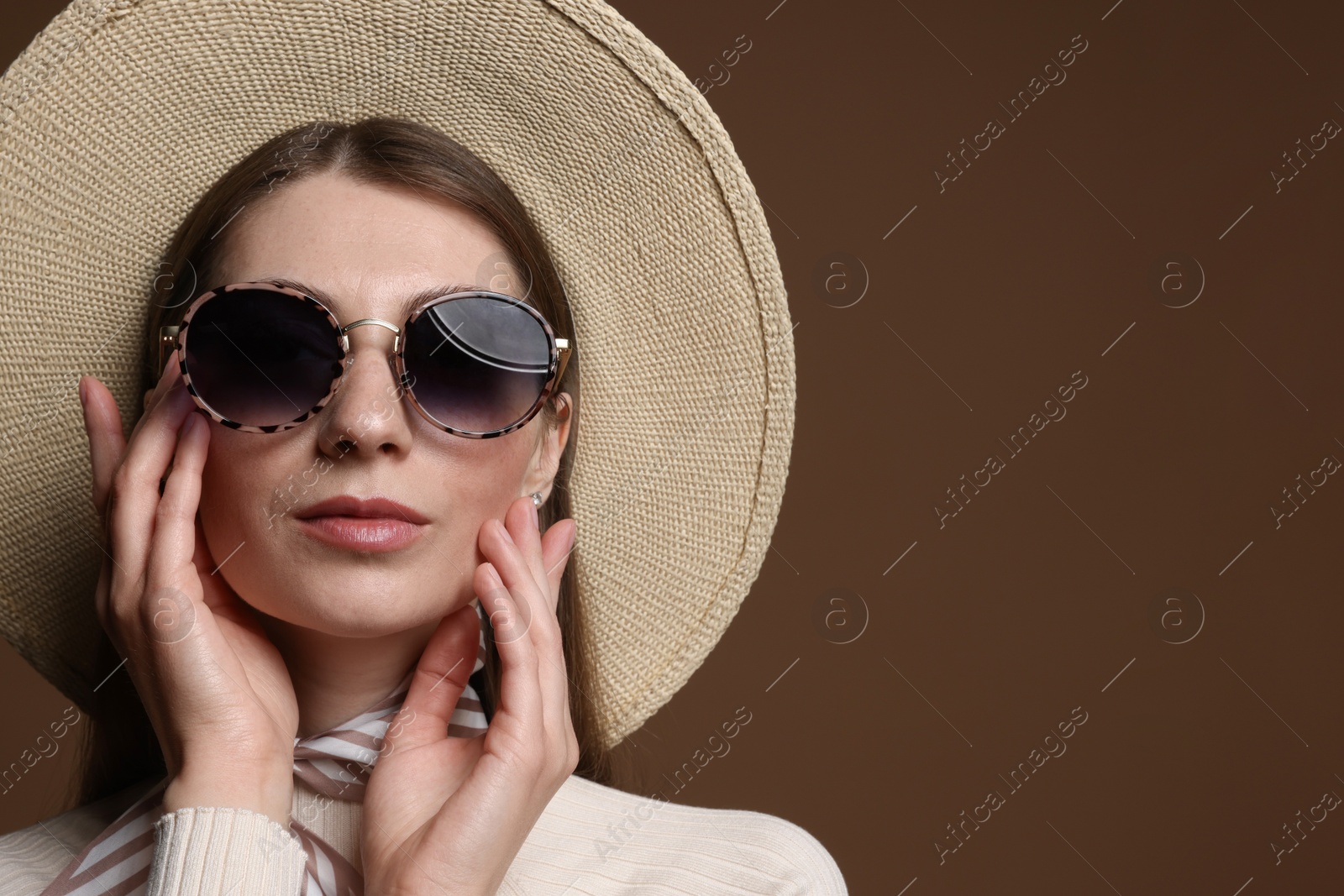 Fashionable portrait of beautiful woman in stylish outfit on brown background. Space for text Photo of Fashionable portrait of beautiful woman in stylish outfit on brown background. Space for text