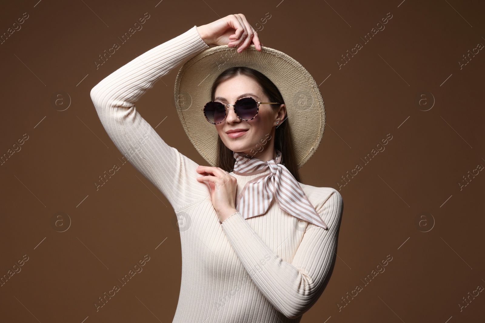 Fashionable portrait of beautiful woman in stylish outfit on brown background Photo of Fashionable portrait of beautiful woman in stylish outfit on brown background