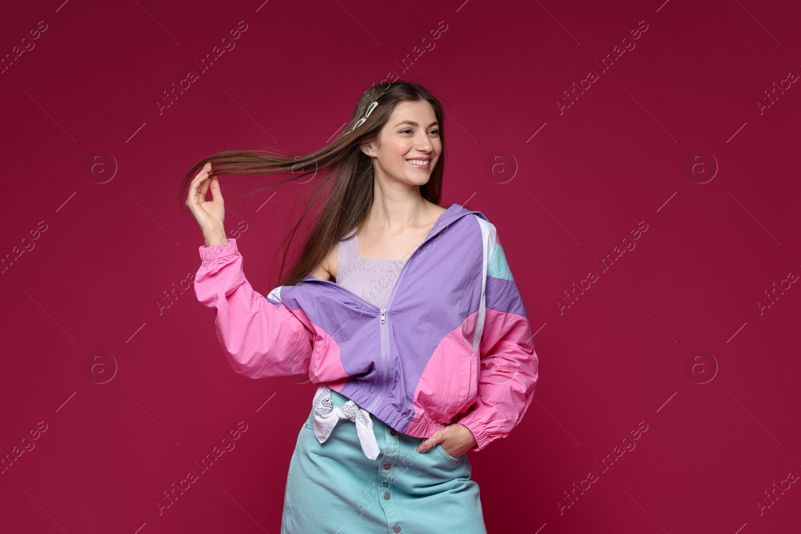 Fashionable portrait of beautiful woman in stylish outfit on crimson background Photo of Fashionable portrait of beautiful woman in stylish outfit on crimson background