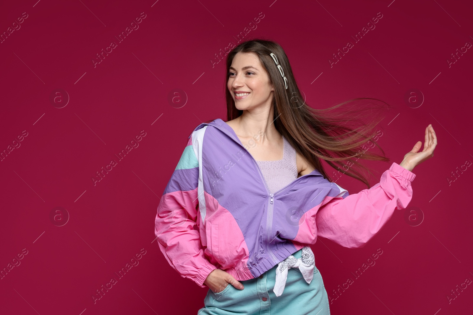 Fashionable portrait of beautiful woman in stylish outfit on crimson background. Space for text Photo of Fashionable portrait of beautiful woman in stylish outfit on crimson background. Space for text