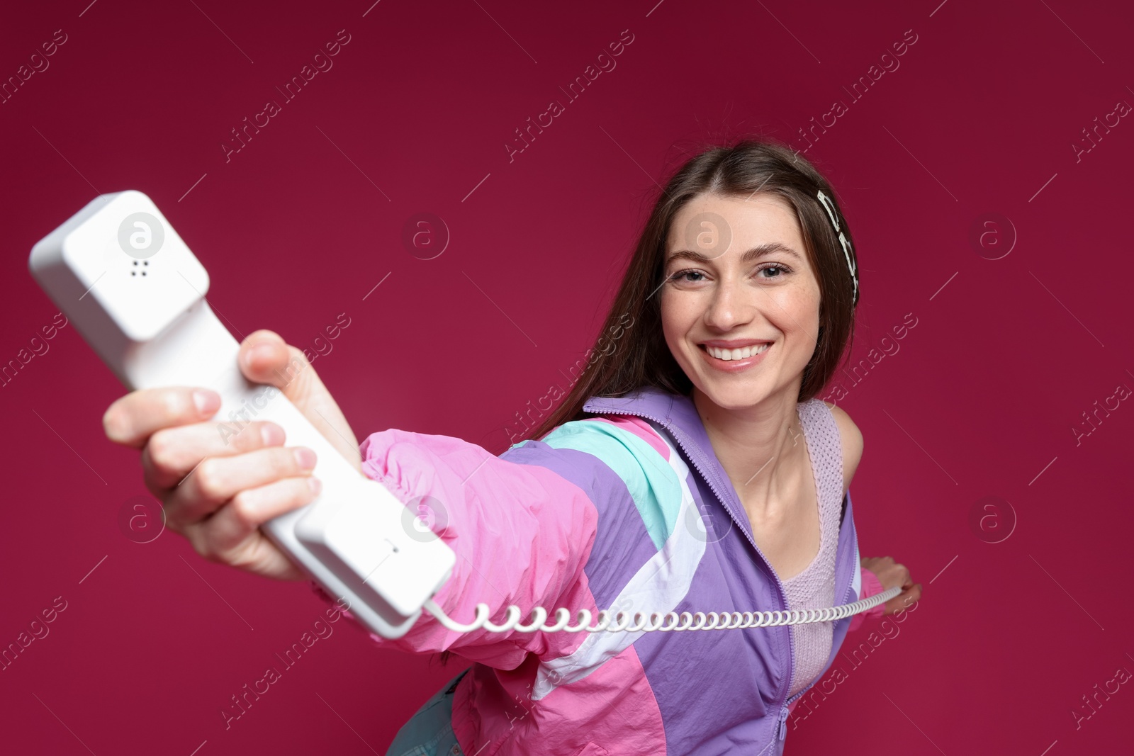 Fashionable portrait of beautiful woman in stylish outfit on crimson background Photo of Fashionable portrait of beautiful woman in stylish outfit on crimson background