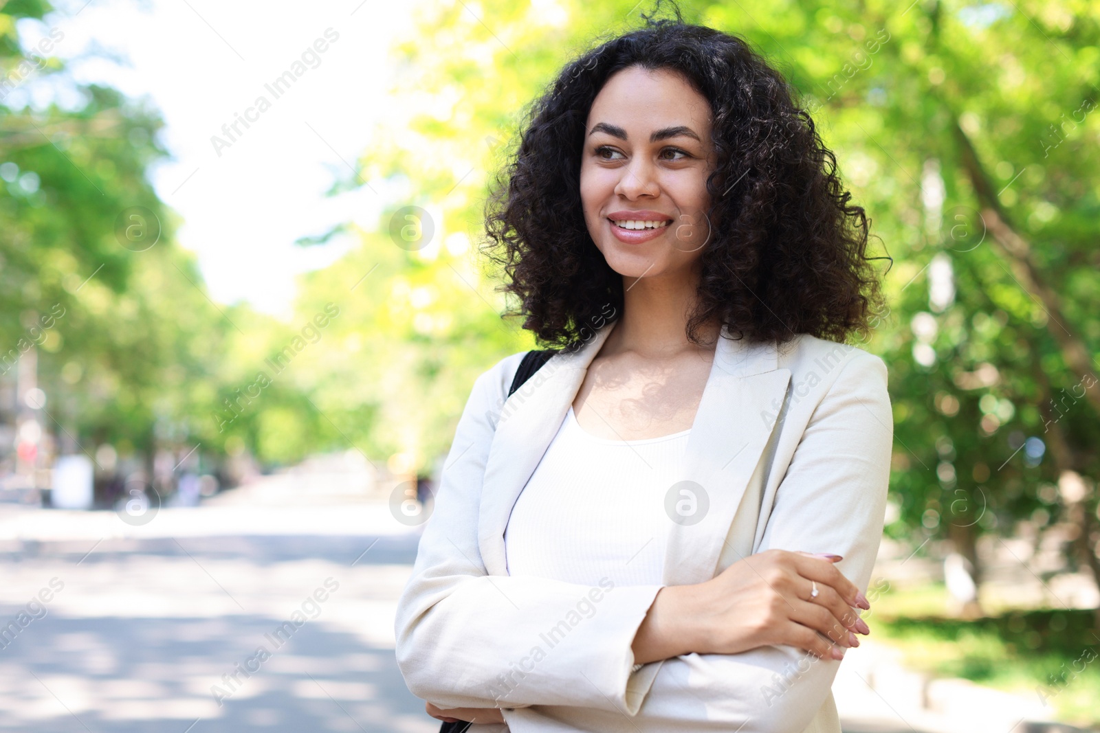 Portrait of smiling Latin American woman outdoors. Space for text Photo of Portrait of smiling Latin American woman outdoors. Space for text