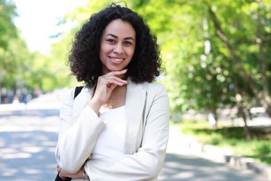 Photo of Portrait of smiling Latin American woman outdoors