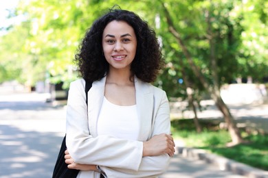 Photo of Portrait of smiling Latin American woman outdoors