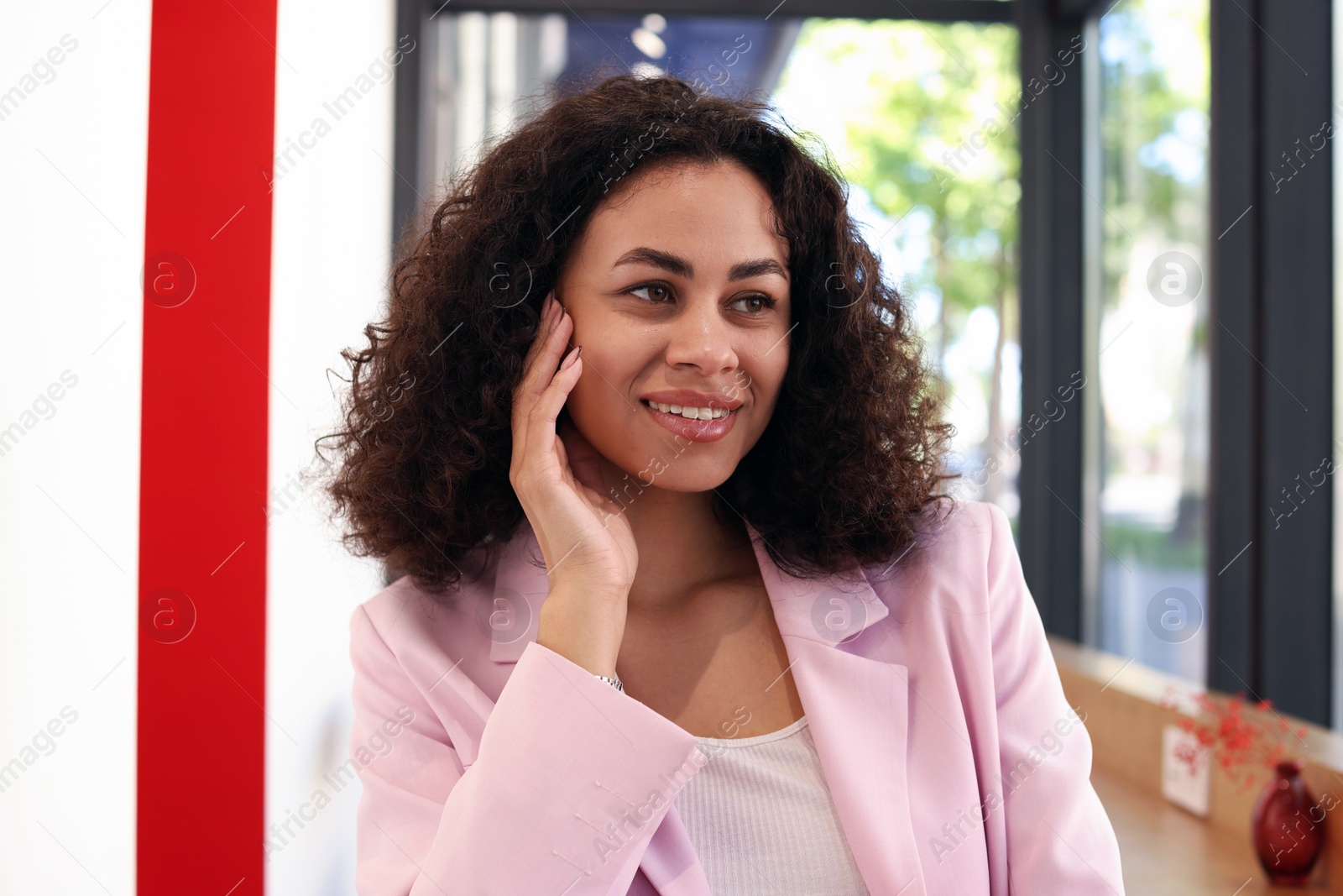 Portrait of smiling Latin American woman in cafe Photo of Portrait of smiling Latin American woman in cafe