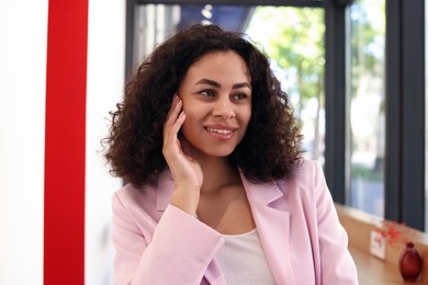Photo of Portrait of smiling Latin American woman in cafe