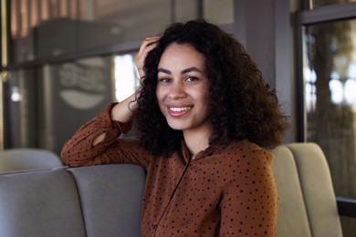 Photo of Portrait of smiling Latin American woman in cafe