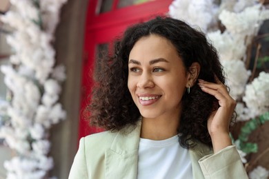 Photo of Portrait of smiling Latin American woman outdoors