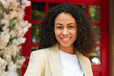 Photo of Portrait of smiling Latin American woman outdoors