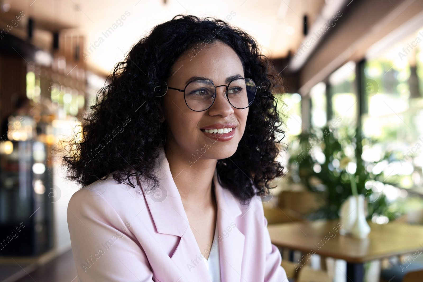 Portrait of smiling Latin American woman in cafe Photo of Portrait of smiling Latin American woman in cafe
