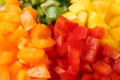 Photo of Pieces of fresh colorful bell peppers with water drops as background, closeup