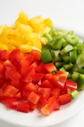 Photo of Pieces of fresh colorful bell peppers on white table, closeup