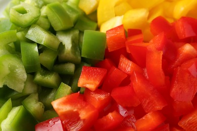 Photo of Pieces of fresh colorful bell peppers as background, closeup