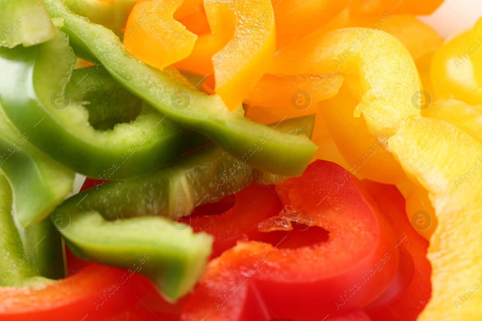 Photo of Slices of fresh colorful bell peppers as background, closeup