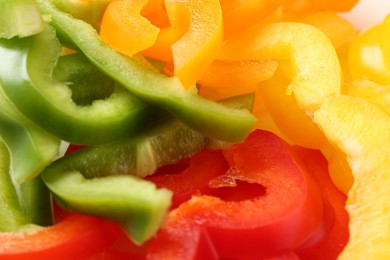 Photo of Slices of fresh colorful bell peppers as background, closeup