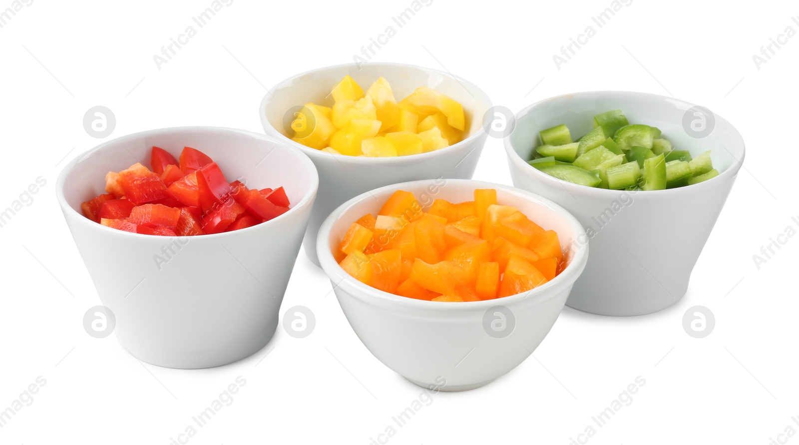 Pieces of fresh colorful bell peppers in bowls isolated on white Photo of Pieces of fresh colorful bell peppers in bowls isolated on white