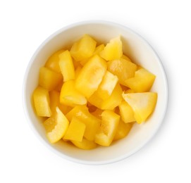 Photo of Pieces of fresh yellow bell peppers in bowl isolated on white, top view