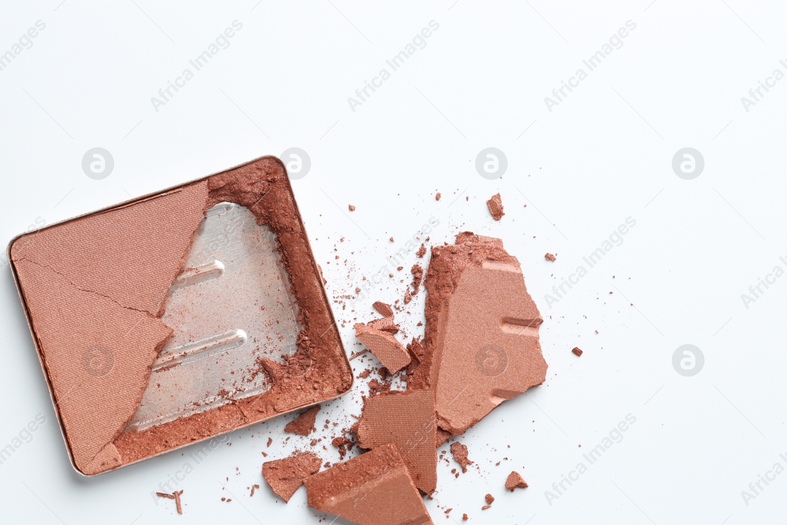 Broken eyeshadow refill pan on white background, top view. Space for text Photo of Broken eyeshadow refill pan on white background, top view. Space for text