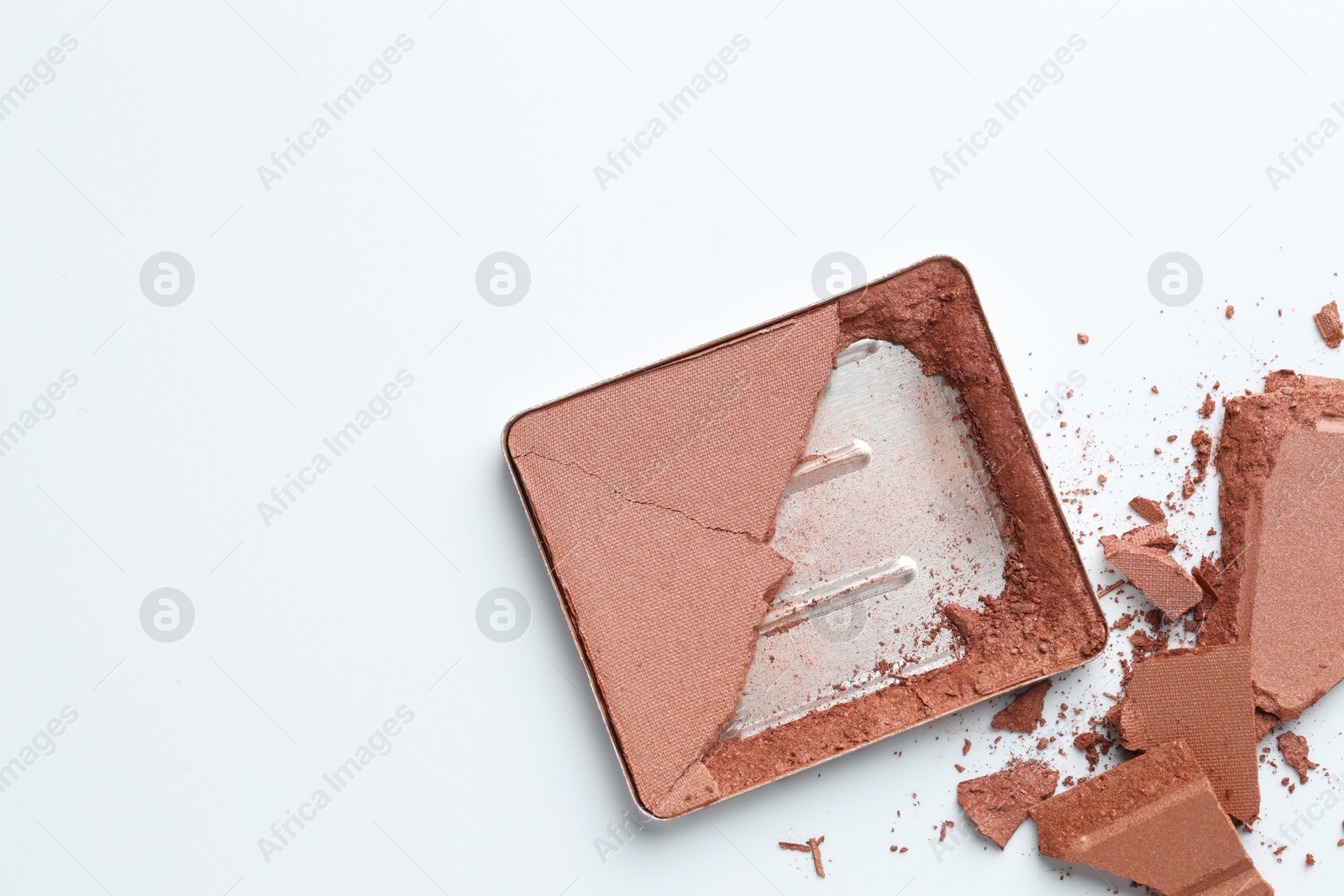 Broken eyeshadow refill pan on white background, top view. Space for text Photo of Broken eyeshadow refill pan on white background, top view. Space for text