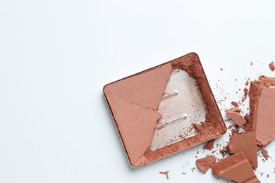 Photo of Broken eyeshadow refill pan on white background, top view. Space for text