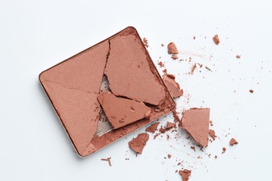 Photo of Broken eyeshadow refill pan on white background, top view