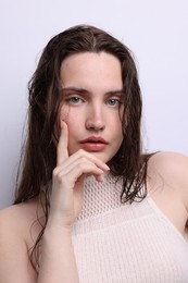 Photo of Portrait of beautiful woman with natural skin complexion on light grey background, closeup