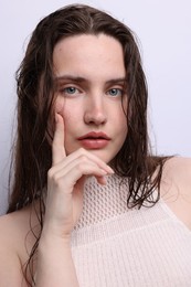 Photo of Portrait of beautiful woman with natural skin complexion on light grey background, closeup