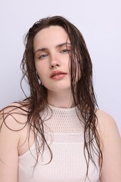 Photo of Portrait of beautiful woman with natural skin complexion on light grey background, closeup