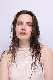 Photo of Portrait of beautiful woman with natural skin complexion on light grey background, closeup