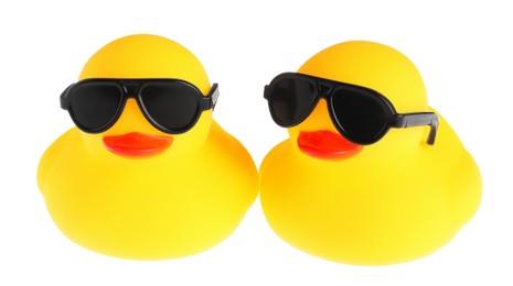 Photo of Cute rubber ducks in sunglasses isolated on white