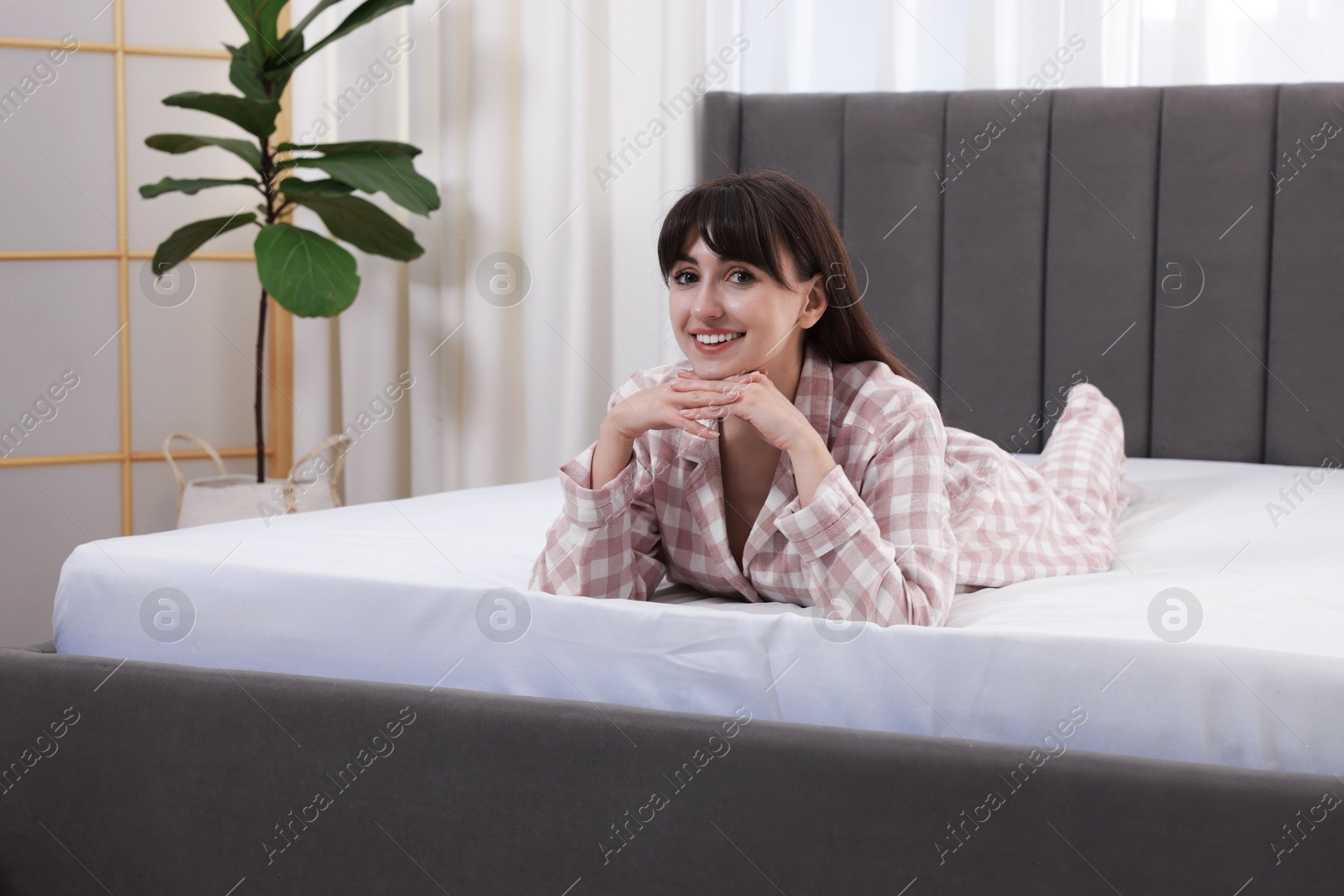 Beautiful woman lying on soft mattress at home Photo of Beautiful woman lying on soft mattress at home