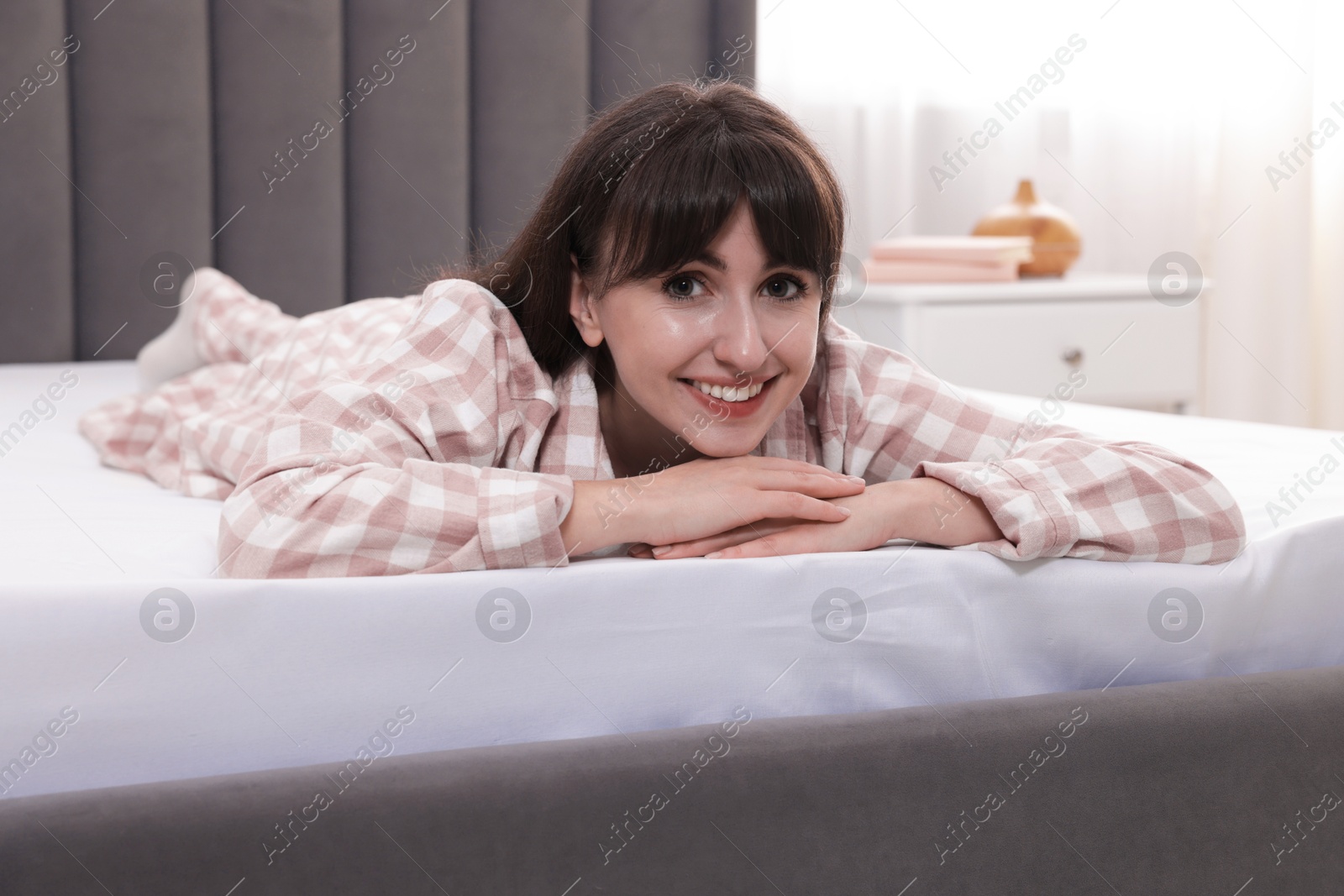 Beautiful woman lying on soft mattress at home Photo of Beautiful woman lying on soft mattress at home