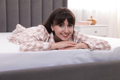 Photo of Beautiful woman lying on soft mattress at home