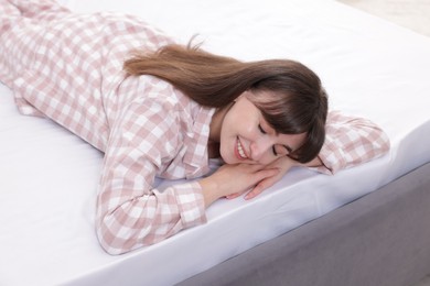 Photo of Beautiful woman lying on soft mattress at home