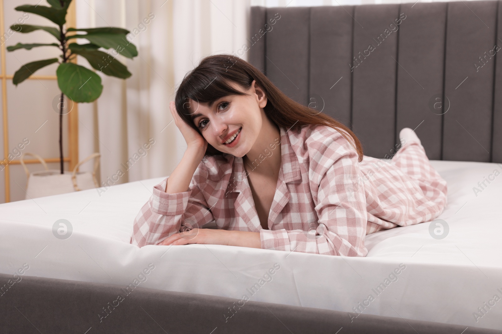Beautiful woman lying on soft mattress at home Photo of Beautiful woman lying on soft mattress at home