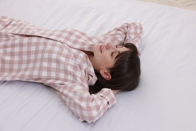 Photo of Beautiful woman lying on soft mattress at home