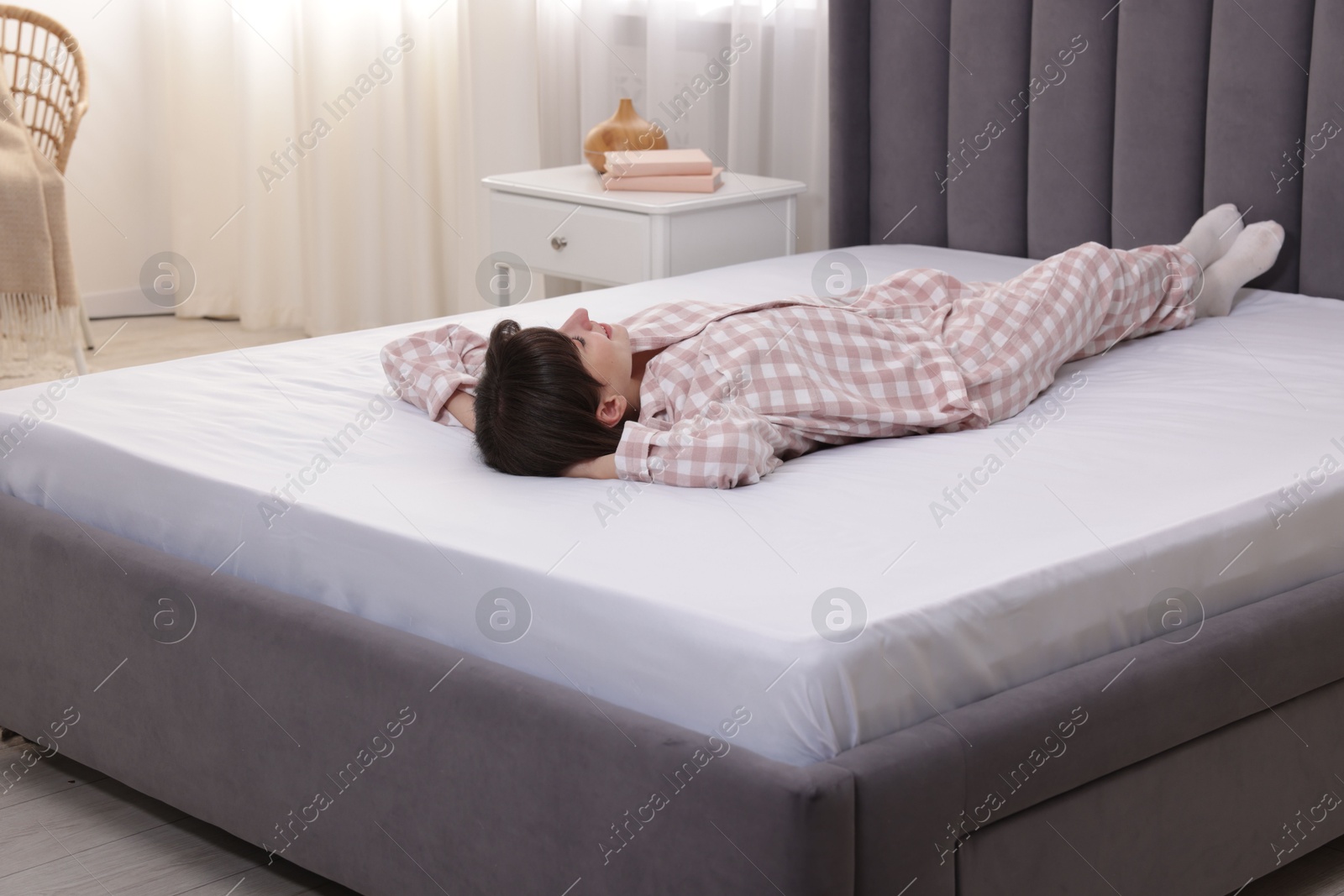 Beautiful woman lying on soft mattress at home Photo of Beautiful woman lying on soft mattress at home