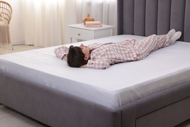Photo of Beautiful woman lying on soft mattress at home