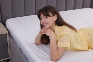 Photo of Beautiful woman lying on soft mattress at home