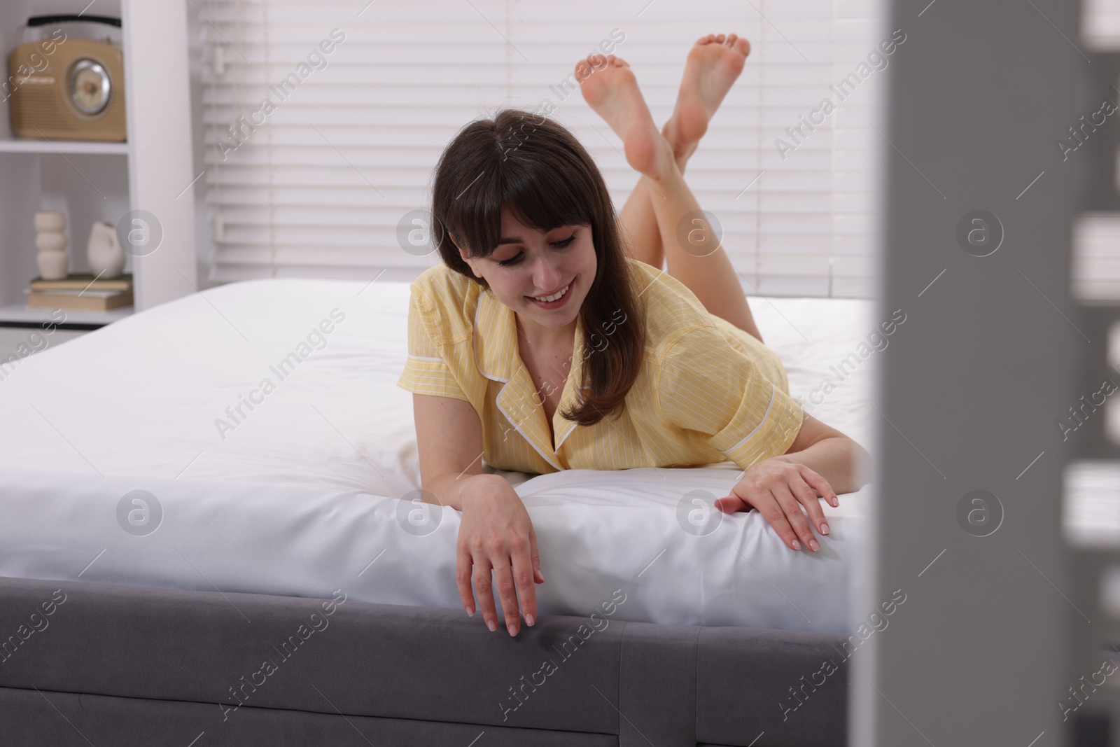 Beautiful woman lying on soft mattress at home Photo of Beautiful woman lying on soft mattress at home