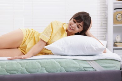 Photo of Beautiful woman lying on bed at home
