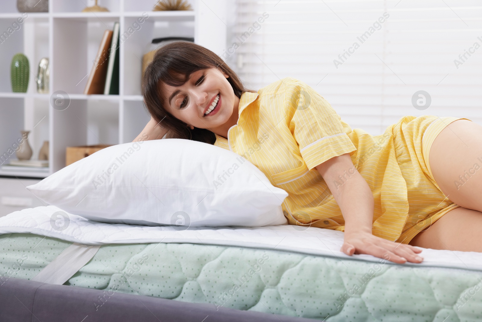 Beautiful woman lying on bed at home Photo of Beautiful woman lying on bed at home
