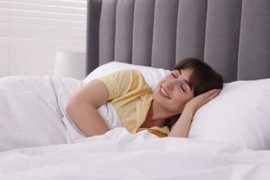 Photo of Beautiful woman sleeping in bed at home