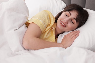Photo of Beautiful woman sleeping in bed at home