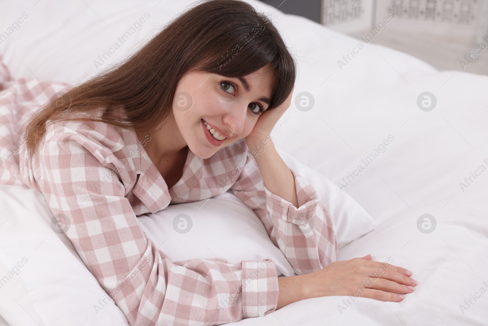 Beautiful woman lying on bed at home Photo of Beautiful woman lying on bed at home